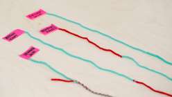 Four lengths of blue and red yarn joined together from Twinkie Chan's Invisible Yarn Joins for Knit and Crochet class on Creativebug.