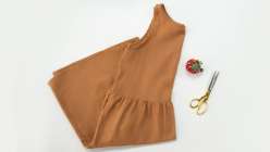 An ocher colored tiered dress made by Sanae Ishida in her Draft and Sew a Tiered Dress class on Creativebug