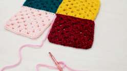Four granny squares being seamed together with a crochet hook in Twinkie Chan's