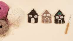 Three crocheted gingerbread houses made by Twinkie Chan in her Holiday Crochet Applique class on Creativebug