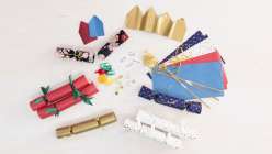 Paper and cloth party crackers, small prizes, and paper crowns made by Cobrina from her Make Prize-Filled Party Crackers class on Creativebug. 