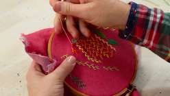 Rebecca Ringquist embroidering the feather stitch in her class on Creativebug.