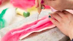 Risa Iwisaki Culbertson felting a layer of wool in her Creativebug class Needle Felting: Three Techniques for Sculpting Tinned Fish.